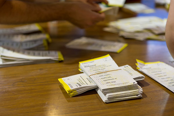 Ballot papers in a stack on a table