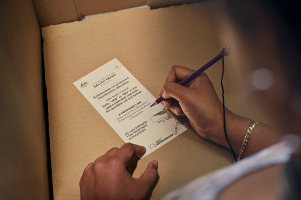 A person completing a referendum ballot paper.
