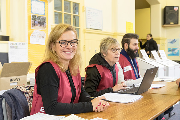 Election officials sitting at a desk at an election office