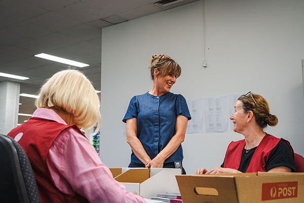 Three staff members working in an election office.