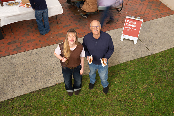 Two people at a voting booth