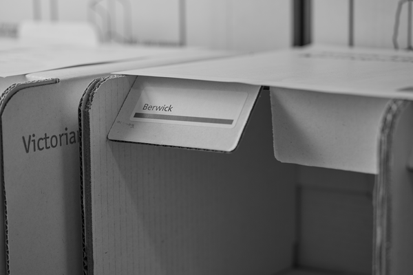 Cardboard cubby for lower house ballot storage. The cardboard flap reads 'Berwick'.