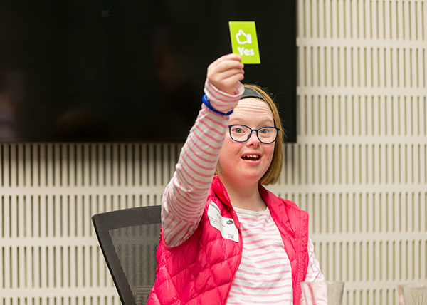 Photo of education session participant holding up a 'yes' card