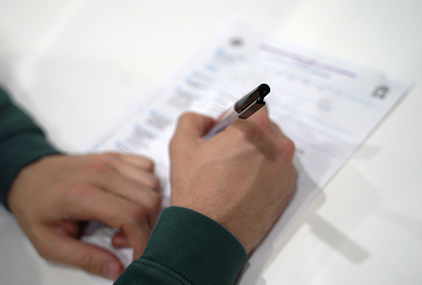A person filling in an enrolment form